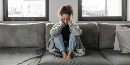 Blog woman sitting on sofa sick
